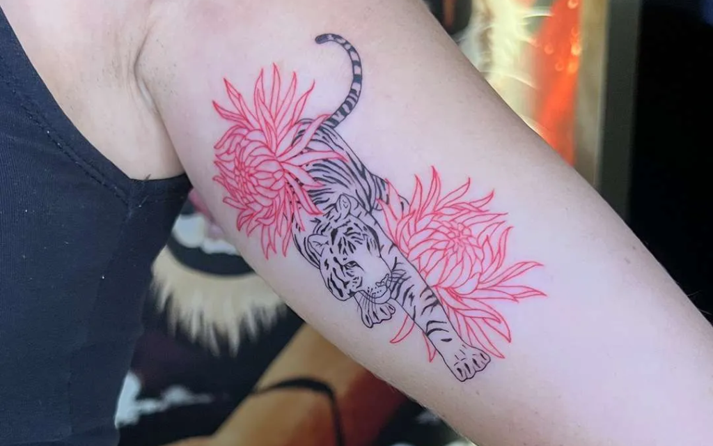 A fineline tiger and flower tattoo from a Canggu tattoo studio.